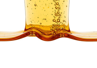 Close up of golden amber liquid with bubbles flowing and splashing in a dynamic wave isolated on transparent background