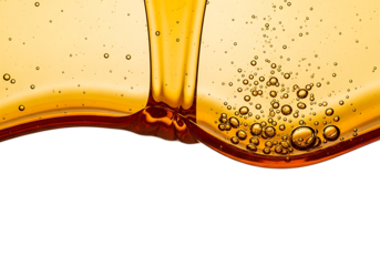 Golden amber liquid pouring and creating bubbles in a dynamic fluid motion isolated on transparent background