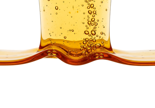 Close up of golden amber liquid with bubbles flowing and splashing in a dynamic wave isolated on transparent background