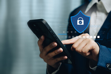 Cybersecurity concept with businessman using smartphone showing digital shield symbol for data privacy protection online safety and secure mobile technology network