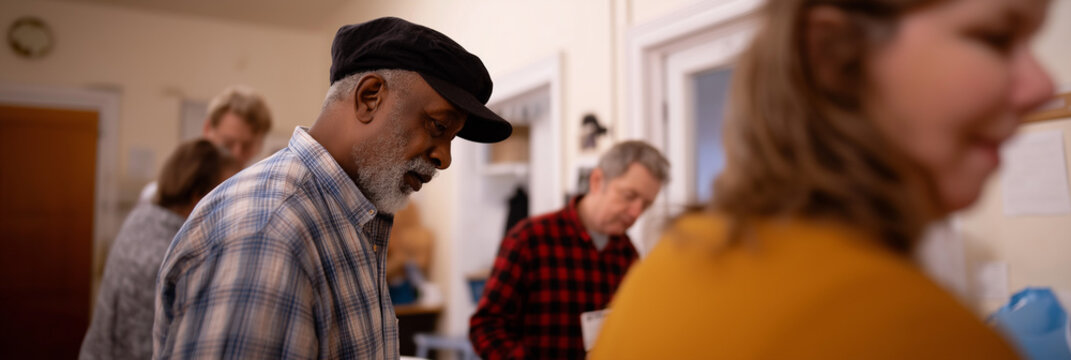 A diverse group of volunteers collaborates in a community space, embodying the spirit of cooperation, empathy, and social responsibility for creating positive change in society.