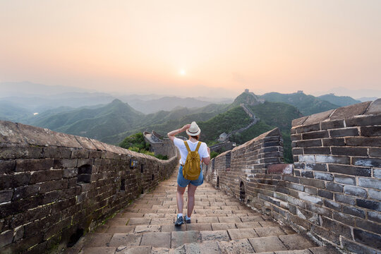 China travel at Great Wall. Tourist in Asia walking on famous Chinese tourist destination and attraction in Badaling north of Beijing. Woman traveler hiking great wall enjoying her summer vacation.