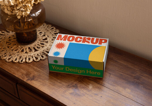 Brown Cardboard delivery Box on Wooden Table Beside Decorative Elements