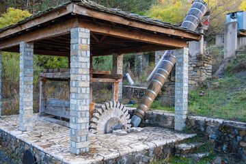 Traditional Stone and Wood Water-Powered Abrasion Machine (Nerotrivi) or Fulling Mill, Showing the Water Wheel and Wooden Barrel Chute, in Samarina, Pindos, Greece
