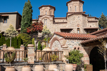 Stone Exterior and Courtyard of the Holy Monastery of Barlaam in Meteora Greece, Featuring Byzantine Domes and Terracotta Pots