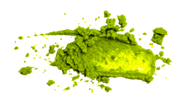 Spicy green wasabi paste smear on a white background creating a vibrant food texture for Japanese cuisine concepts