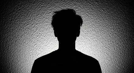Dark silhouette of an anonymous man. Unidentifiable person representing privacy and security. Mental health concept of a hidden identity. Unknown user profile or witness protection