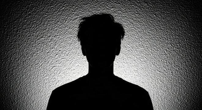 Dark silhouette of an anonymous man. Unidentifiable person representing privacy and security. Mental health concept of a hidden identity. Unknown user profile or witness protection