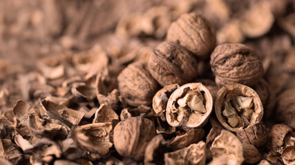 Walnuts laid out on a table covered in jute with a beautiful rustic bokeh.