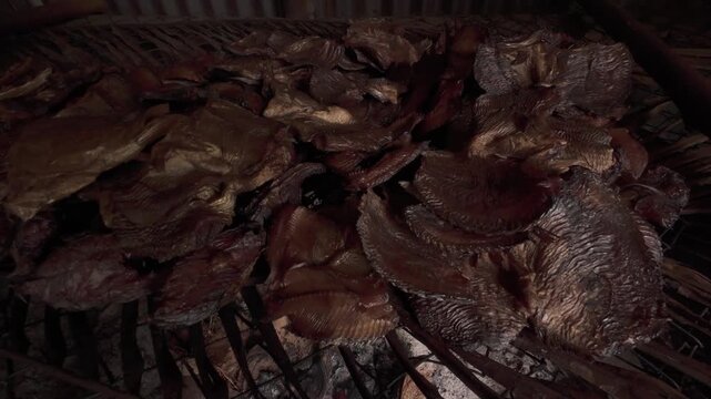 4K 60 FPS video of the process of making smoked fish, a food with traditional and environmentally friendly preservation practices in Merauke, Papua.