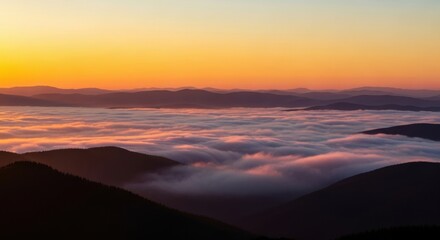 Majestic mountain landscape above the clouds at dawn. Golden hour sunrise over a sea of fog. Layered mountain silhouettes creating depth. Inspirational nature for travel and adventure concepts