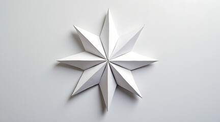 Obraz premium Simple paper star folded with precision casting soft shadows on clean white surface, evoking calm and minimalistic elegance
