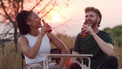 Happy multiracial couple toasting and drinking beer at sunset - Powered by Adobe