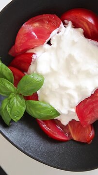 Salad strachatella and tomato portion size natural product tasty snack fresh delicious gourmet food background on the table rustic top view copy space keto and paleo diet