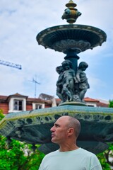 Man in front of a fountain