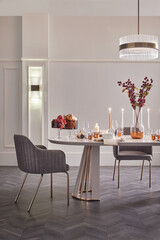 Vertical shot of an elegant dining room. Modern festive table setting for a holiday like Thanksgiving or Christmas.