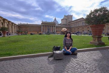 girl sitting on the ground in a garden