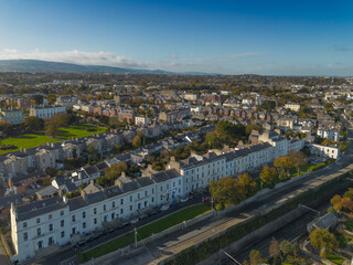 Stunning aerial shot of traditional white terraced georgian architecture and residential areas in blackrock, dublin on a clear autumn day