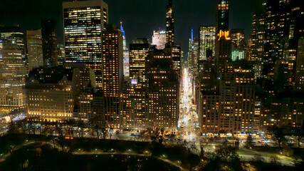 Panoramic view of a dense city skyline at night. Thousands of windows glow with light, creating a mesmerizing pattern. Ideal for marketing, technology, or business themes.