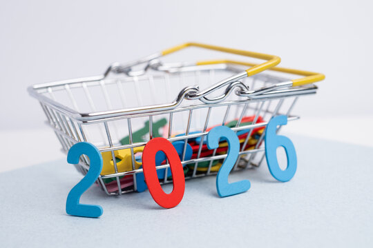 Planning goals for 2026: miniature shopping basket spilling out colorful letters and numbers on a pastel background.