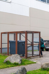 Naklejka premium Waste Bins in Caged Enclosure at Industrial Site