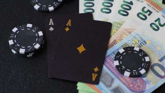 Playing blackjack or baccarat card game in casino with chips, bets and risk. Cards and chips on black felt as background for your design