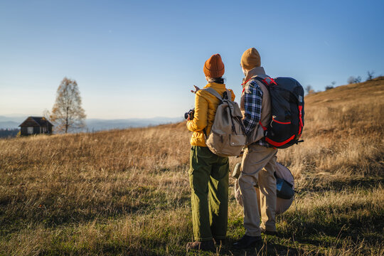 Couple hiking mountain trail pointing view outdoors - Powered by Adobe