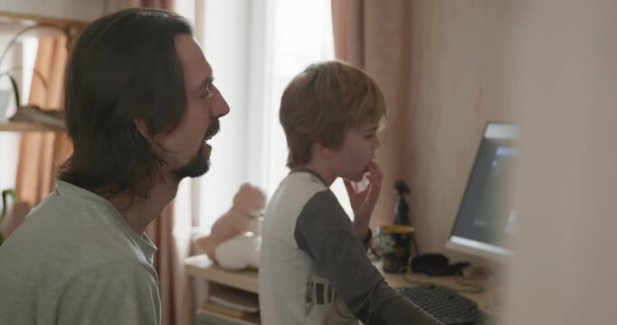 Man Teaches Kid Boy to Play Chess on Computer. 4K 10-bit