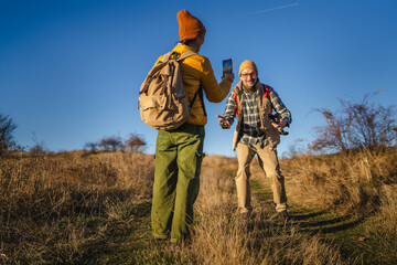 Traveler recording friend for blog or social media