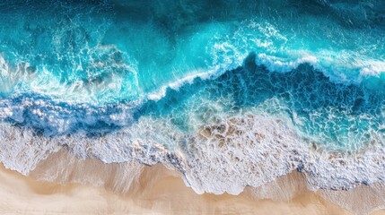 Fototapeta premium Turquoise waves crash down onto a sandy beach, creating white foam as they recede. The scene is bright and clear, showcasing a vibrant coastal landscape under the sun.