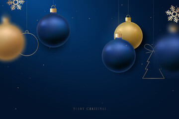 Elegant blue and gold ornaments hang against deep backdrop, evoking festive cheer. Merry Christmas background.