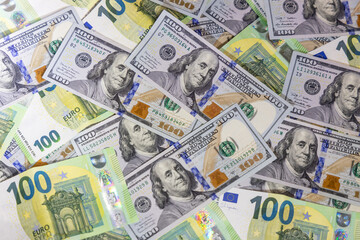 US dollar and Euro banknotes arranged on flat surface featuring currency details, denominations and textures representing finance, economy, global trade, investment, banking and international monetary