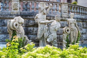 Baroque statues on the grounds of Moszna Castle in Poland. Stone mythological figures, a scene from Greek mythology.