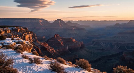 Winter sunrise over the Grand Canyon with snow on the rim. Famous Arizona landmark and travel destination. Vast geological landscape for outdoor adventure and tourism marketing