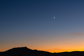 Rhune Mountain in Arcangues by night and crescent moon in the sky. Basque Country.
