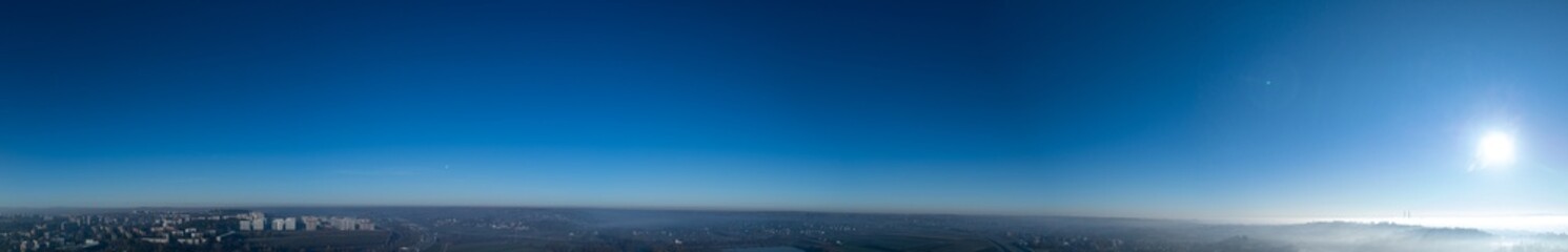 Vast Blue Sky Panorama Over Foggy Urban Landscape