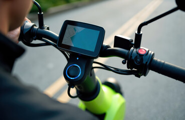 Naklejka premium Electric bicycle handlebar with digital display and control buttons on a city street