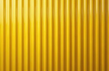Bright yellow corrugated metal wall. Vertical lines create pattern. Textured surface creates repeating design. Modern industrial exterior building detail. Simple abstract construction.