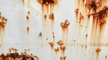 Grunge white painted metal texture with heavy vertical rust stains. Abstract industrial background.