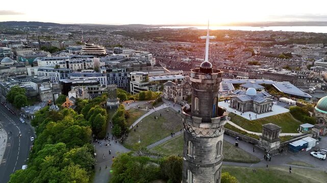 Aerial view of Calton Hill and Edinburgh Scotland at sunset showcasing the Dugald Stewart Monument Nelson Monument and cityscape