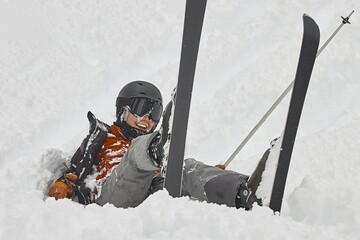 Skiing in the winter woman fallen over