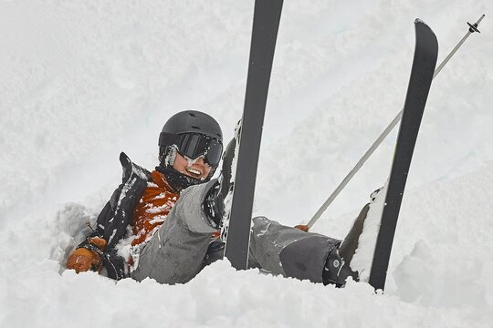 Skiing in the winter woman fallen over