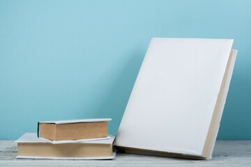 Open book, hardback colorful books on wooden table. Back to school. Copy space for text. Education business concept.