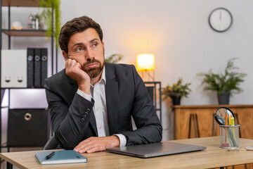 Middle-aged businessman at home office shuts laptop fast and annoyed by boring task. Freelancer guy...