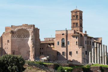 Ancient ruins of the Temple of Venus and Roma alongside the Basilica of Santa Francesca Romana, Santa Maria Nova in Rome, Italy © natatravel