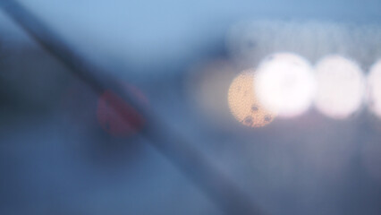 A transparent umbrella and a street out of focus, an autumn city in cloudy weather, melancholic bokeh