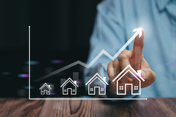 Real estate growth concept. Businessman analyzing housing market trends and property investment with financial graph showing increasing home value and profit growth.