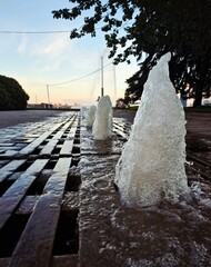 Working fountain in the center of Dnipro city at sunset
