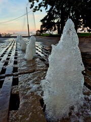 Working fountain in the center of Dnipro city at sunset