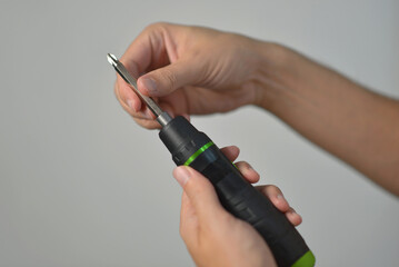 A man changing drill bit in electric screwdriver